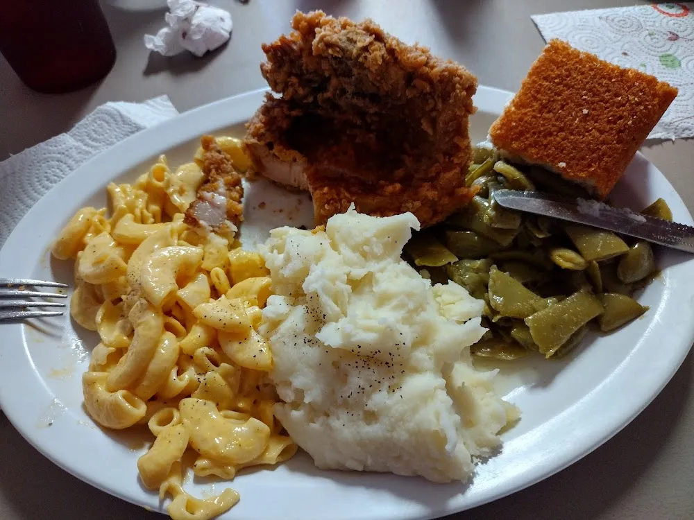 Pork Chop with Creamed Potatoes Green Beans Mac N Cheese and Cornbread